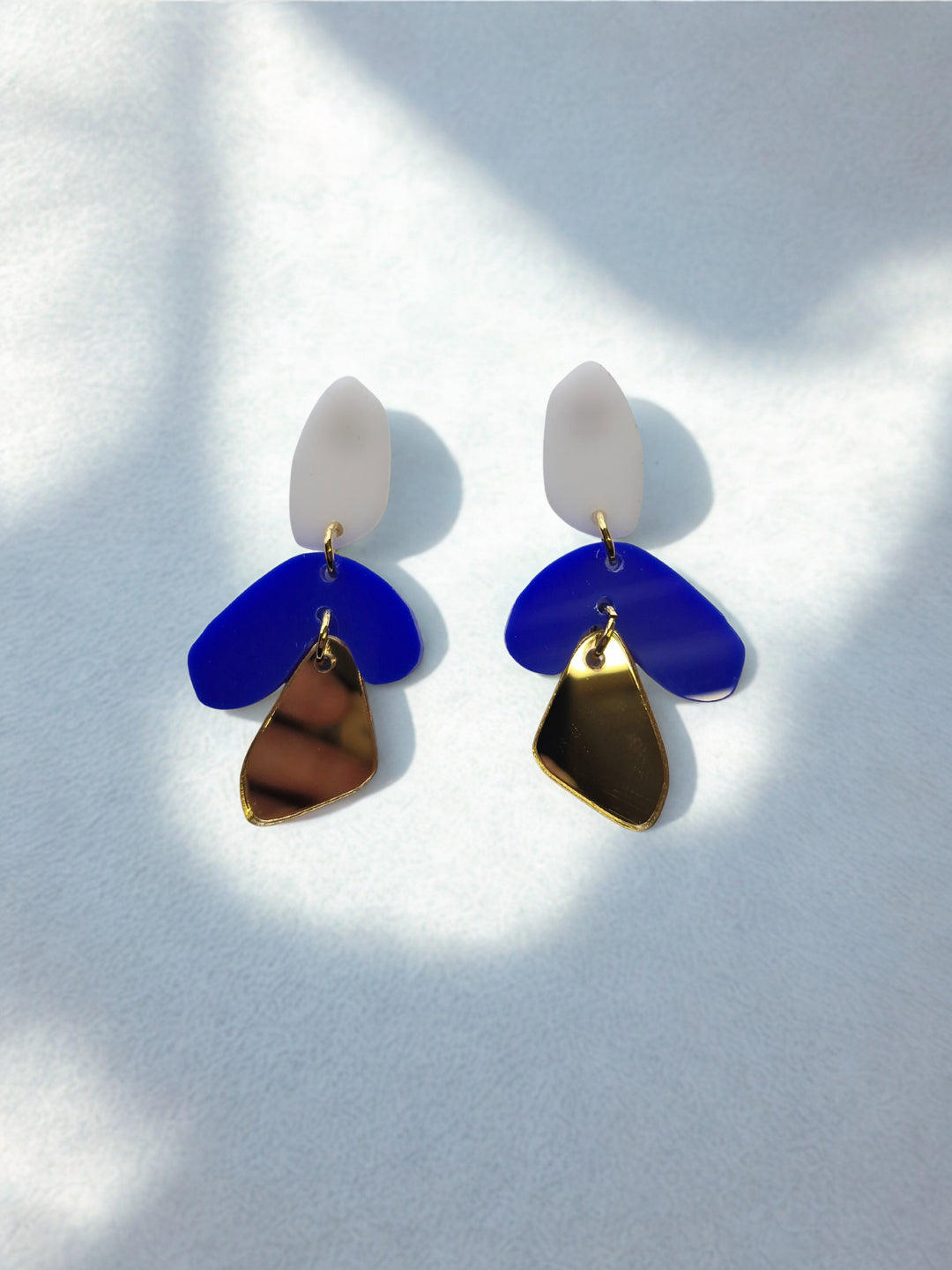 Blue and gold pair of  statement earrings by Capulet and Montague